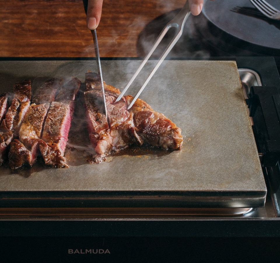 Steak being sliced on BALMUDA The Teppanyaki
