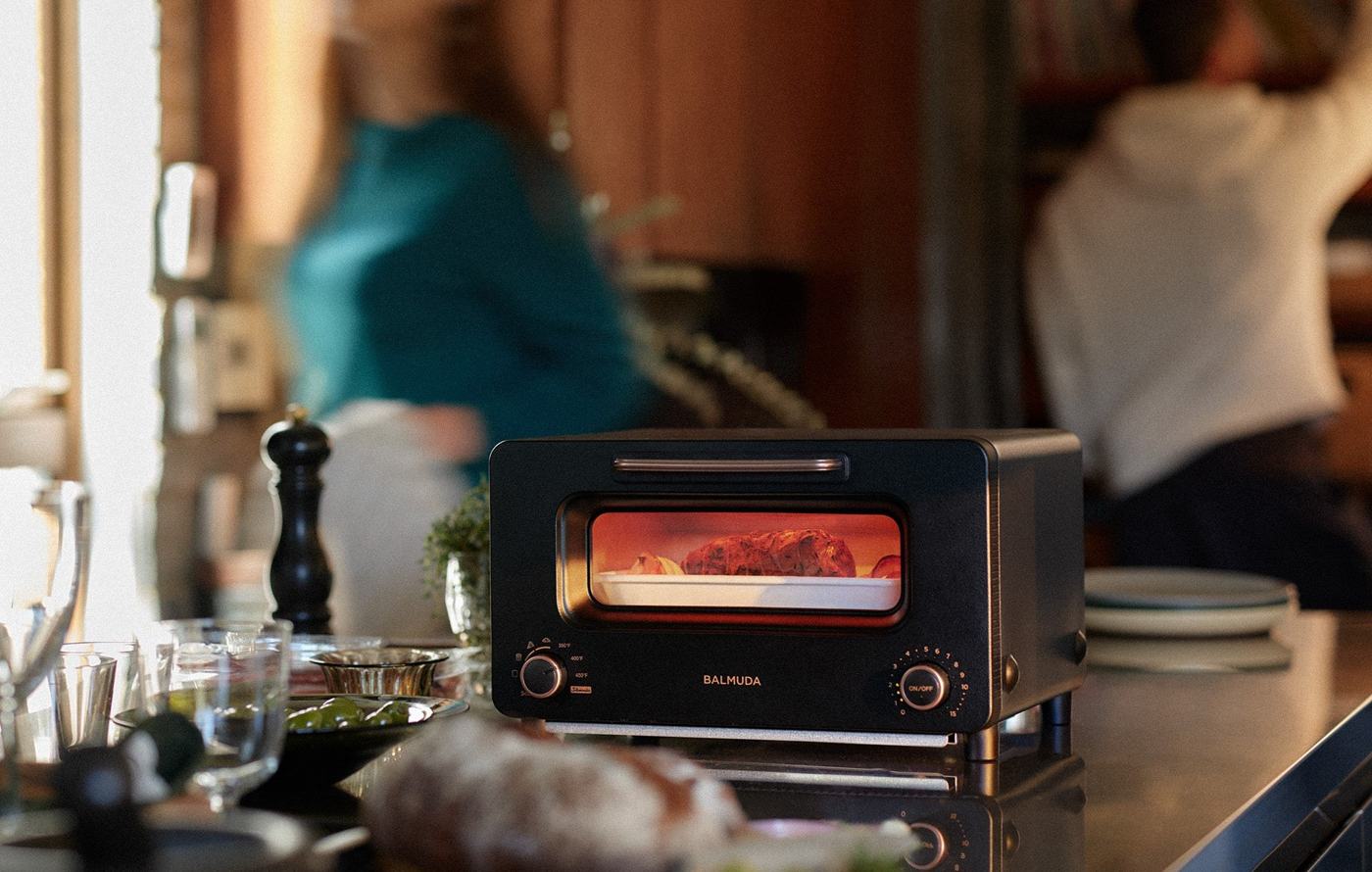 BALMUDA The Toaster Pro glowing on a kitchen counter