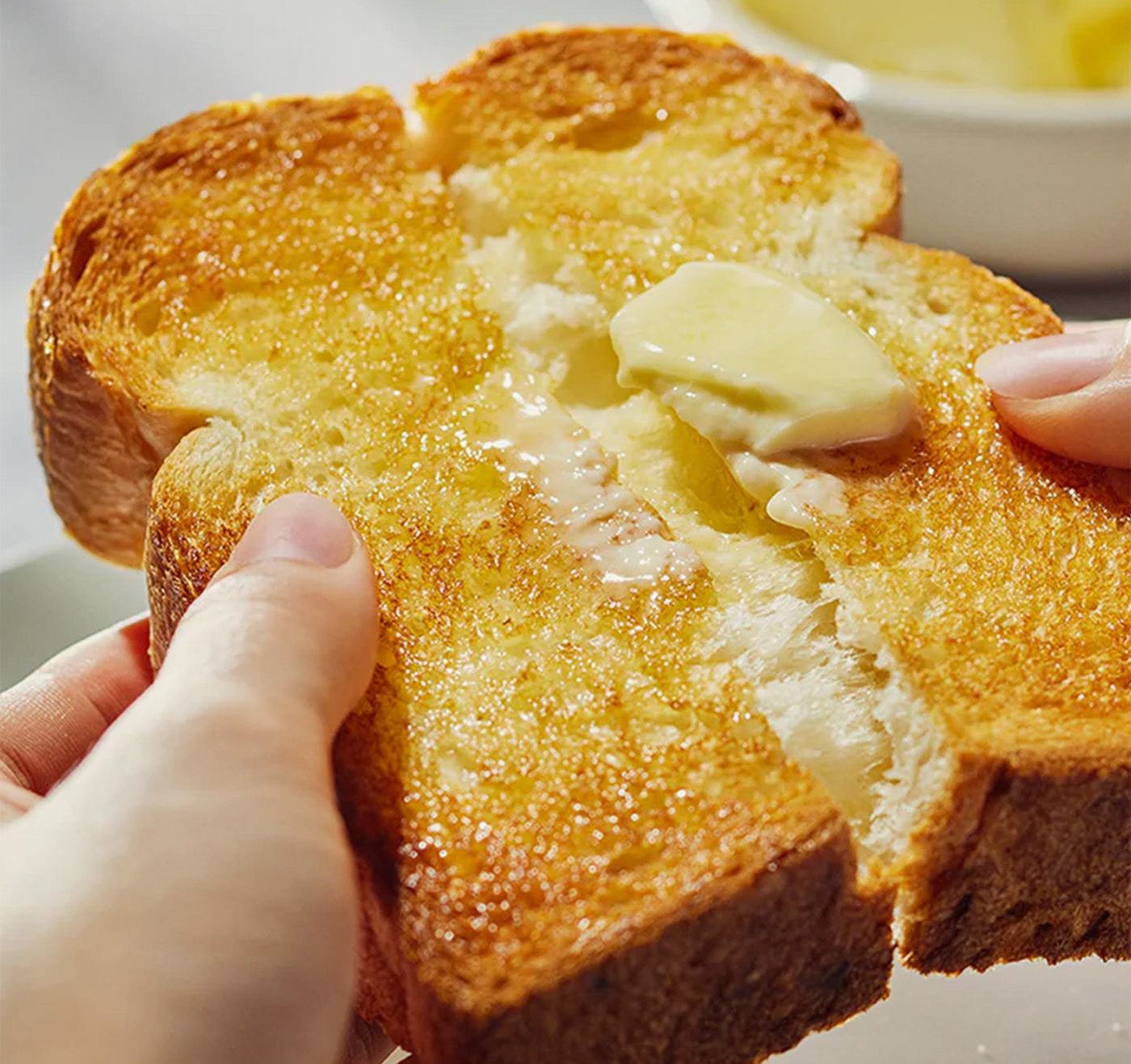 A thick slice of buttered toast pulled apart