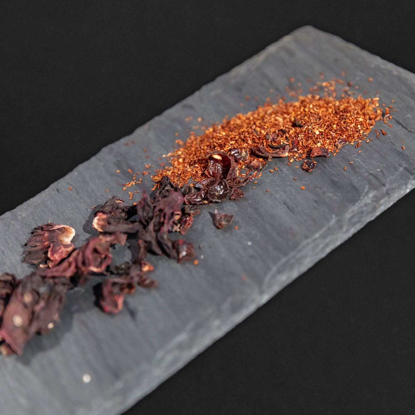 Rooibos and dried hibiscus on slate