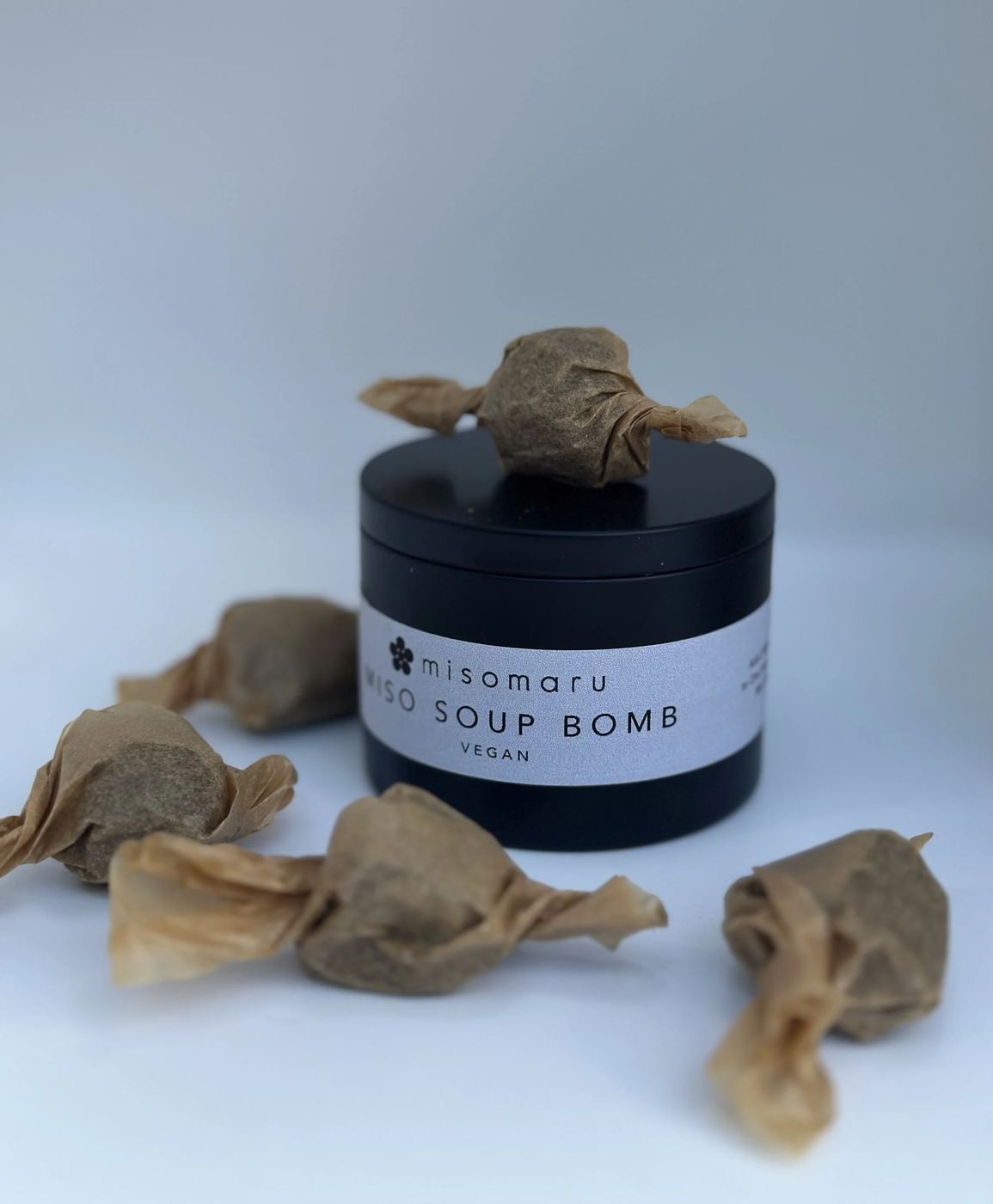 A MISOMARU miso soup bomb tin with single portions twisted in paper