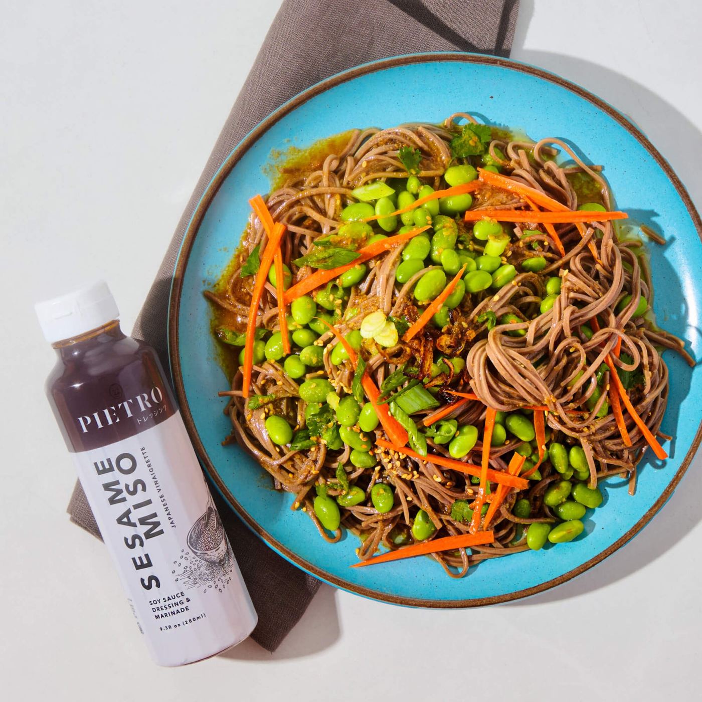Soba noodles with edamame and carrot, PIETRO Sesame Miso beside